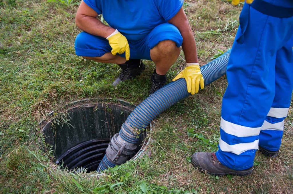 Two men pumping out a septic tank